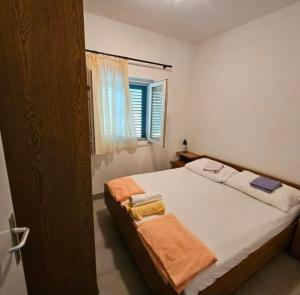 a bedroom with a bed with towels on it at Stunning Sea View in Central Postira in Postira