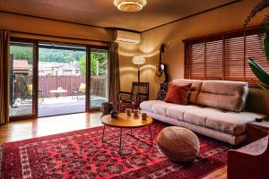 a living room with a couch and a table at Nikko Botan - 3 Min Walk from JR Nikko Station in Nikko