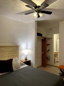 a bedroom with a ceiling fan and a bed at Casa Rincón Colonial I Confort y Tranquilidad in El Santuario