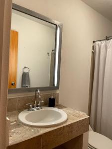 a bathroom with a sink and a mirror at Casa Rincón Colonial I Confort y Tranquilidad in El Santuario