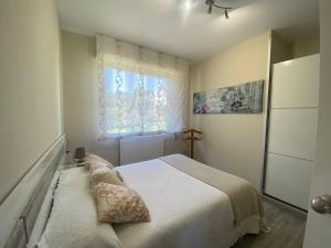 a bedroom with a bed with pillows and a window at Lar de Mamita in Cristiñade +31 photos