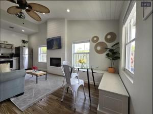 a living room with a table and a couch at Endless Summer Cottage - Steps off Atlantic! in Delray Beach +23 photos