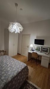 a bedroom with a bed and a desk and a lamp at Affittacamere Borgo Antico in Venzone