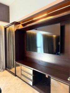a large entertainment center with a large flat screen tv at Tropical Executive Confort in Manaus
