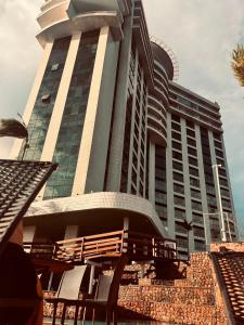 a large building with chairs in front of it at Tropical Executive Confort in Manaus