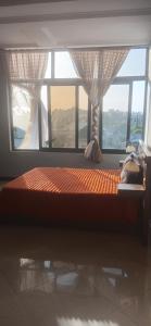 a bed in a room with a large window at Bishoftu Bliss in Debre Zeyit