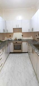 a kitchen with white cabinets and a stove at Bishoftu Bliss in Debre Zeyit