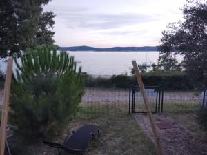 a chair in a yard with a view of the water at Bungalov A in Sveti Filip i Jakov