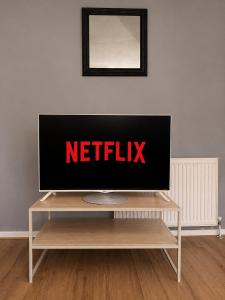 a flat screen tv sitting on top of a table at Large river side house, parking,for 9 people in Bedford
