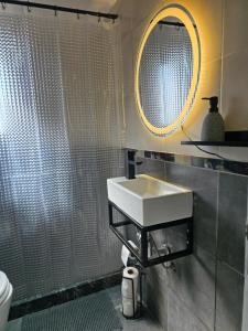 a bathroom with a sink and a mirror at NAT home in San Lorenzo +12 photos