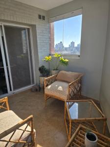 a room with a balcony with a bed and a window at NAT home in San Lorenzo