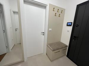 a room with a door with a stool in it at Stan na dan - SResidence Banja Luka in Banja Luka +37 photos