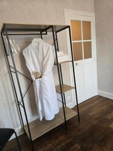 a shelf with a white shirt on it in a room at L'argonnière in Buzancy