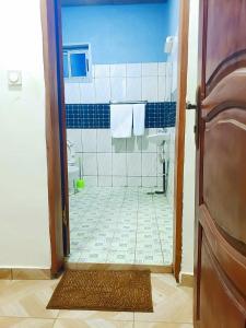 a bathroom with a shower with a sink and a toilet at M & S Multipurpose Center in Yaoundé