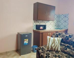 a living room with a chair and a refrigerator at M & S Multipurpose Center in Yaoundé
