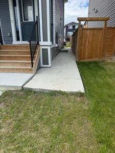 a porch of a house with a wooden fence at The Cozy Nook in Cochrane