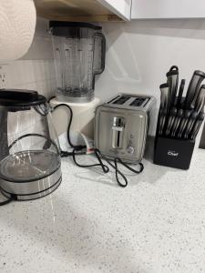 a kitchen counter with a blender and a toaster at The Cozy Nook in Cochrane +22 photos