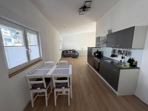 a kitchen with a table and a counter top at Moselpanorama91 in Briedel