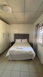 a bedroom with a large white bed in a room at River Gates Home in Rundu