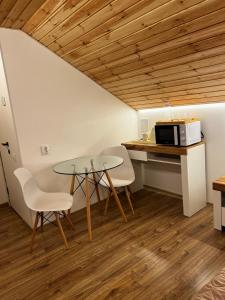 a kitchen with a table and two chairs and a microwave at Lukas Hotel in Muravitsa