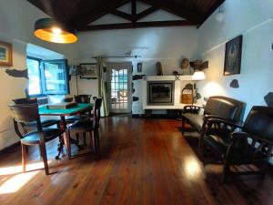 a living room with a dining room table and chairs at Casa dos Santos Historic Azorean Estate in Horta