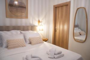 a bedroom with a bed with two towels on it at Boho Nook Apartment in Rethymno