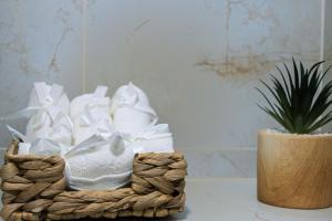 a basket of towels on a table next to a plant at Lighthouse Kotor in Prčanj +9 photos