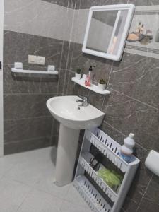 a bathroom with a sink and a mirror on the wall at Dardyafa in Larache +6 photos