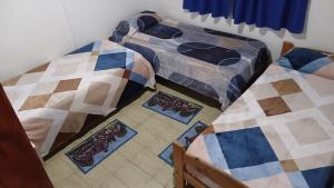 two beds sitting next to each other in a room at DepartamentosJYM in Federación