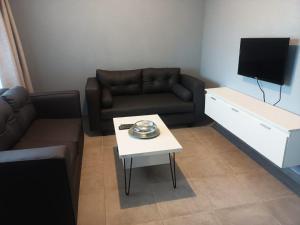 a living room with a couch and a table at Lifeshed Guest Home in Johannesburg