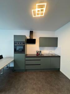 a kitchen with green cabinets and a counter top at Luxuriöse Apartment in Bochum
