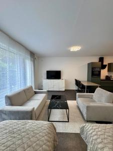 a living room with two couches and a table at Luxuriöse Apartment in Bochum