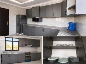 a kitchen with gray cabinets and a blue object at Kigali Clever Homes Villa in Kigali