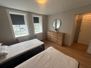 Llit o llits en una habitació de Lárubúð