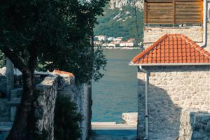 a building with a view of a body of water at Lighthouse Kotor in Prčanj