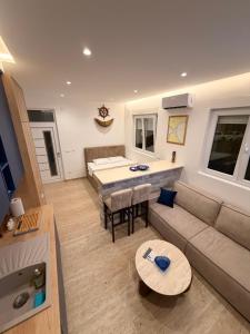 a living room with a couch and a table at IK Apartments in Rake
