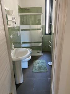 a bathroom with a sink and a toilet and a shower at La dimora del borgo antico in Pulsano