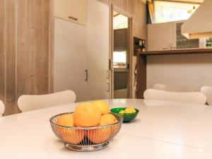 a bowl of oranges sitting on a kitchen counter at 5 star holiday home in Væggerløse in Bøtø By