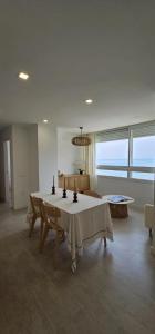 a living room with a table and a couch at SeaFront Horizon in Sitio de Calahonda