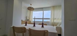 a dining room table with a view of the ocean at SeaFront Horizon in Sitio de Calahonda +25 photos