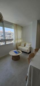 a living room with a couch and a table at SeaFront Horizon in Sitio de Calahonda