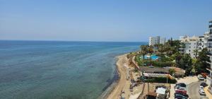 an aerial view of a beach with buildings and the ocean at SeaFront Horizon in Sitio de Calahonda