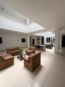 a large living room with couches and tables in a building at ConfortTrust Hotel in Ocaña