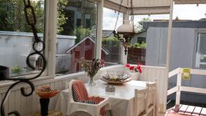 a white table and chairs on a screened porch at Amazing villa with garden in Kolding