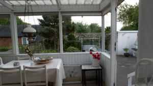 a white pergola with a table and chairs on a patio at Amazing villa with garden in Kolding +27 photos