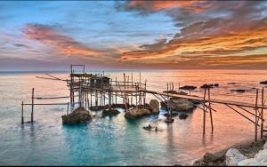 a dock in the water with people in the water at CasaLù in Lanciano