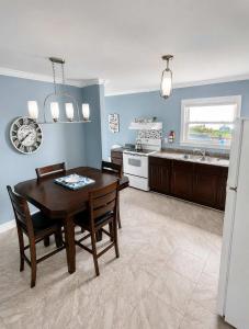 a kitchen with a table and chairs and a dining room at Whistler's View in Twillingate