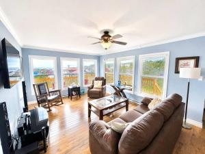 a living room with a couch and a ceiling fan at Whistler's View in Twillingate