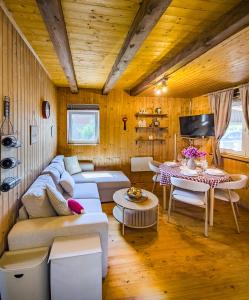 a living room with a couch and a table at Velebit House in Baške Oštarije