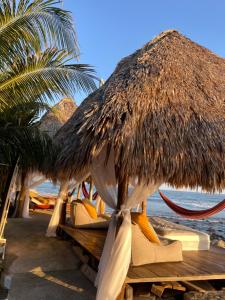 a group of umbrellas and chairs on a beach at Punta El Zonte in El Zonte